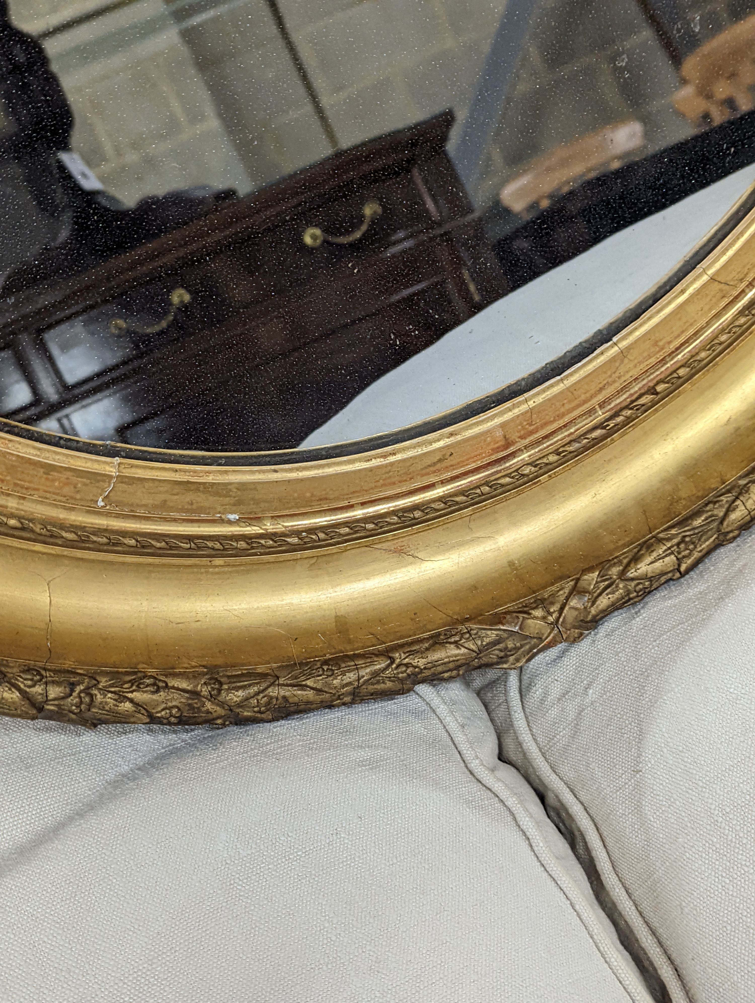 A Victorian oval giltwood and gesso wall mirror, width 80cm, height 94cm